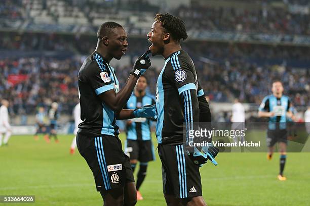 Michy Batshuayi of Marseille celebrates with his team mate Benjamin Mendy after scoring the first goal during the French Cup game between US...