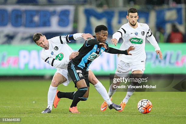 Matthias Jouan and Antoine Peron of Granville and Georges Kevin Nkoudou of Marseille during the French Cup game between US Granville V Olympique de...