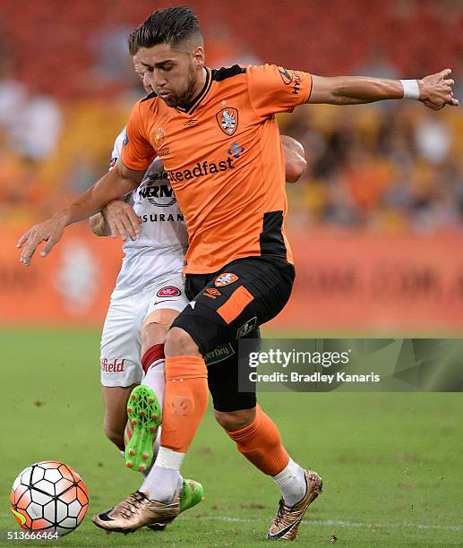 Dimitri Petratos of the Roar attempts to break away from the defence of Scott Jamieson of the Wanderers during the round 22 A-League match between...