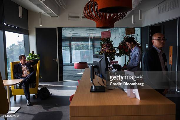 Employees gather at the reception area of the Microsoft Corp. Office and Experience Center during a media event for the opening of the workspace in...