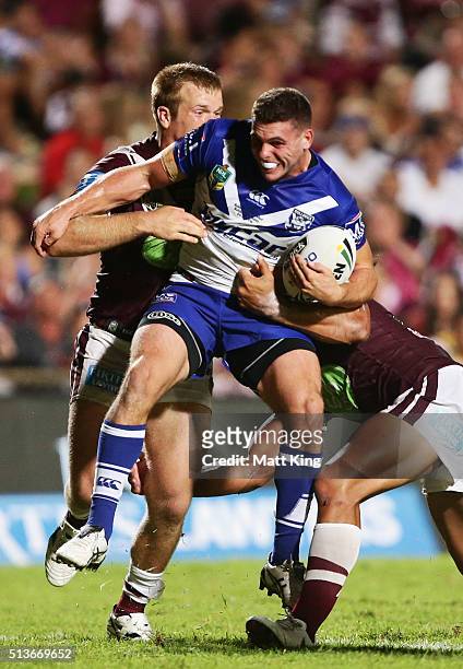 Adam Elliott of the Bulldogs is tackled during the round one NRL match between the Manly Warringah Sea Eagles and the Canterbury Bulldogs at...