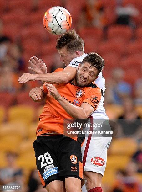 Brandon Borrello of the Roar and Scott Jamieson of the Wanderers challenge for the ball during the round 22 A-League match between the Brisbane Roar...