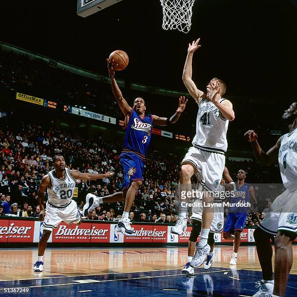 Allen Iverson of the Philadelphia Sixers drives to the basket against the Dallas Mavericks during a NBA game at the Reunion Arena circa 2000 in...