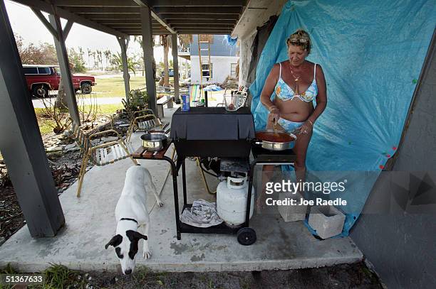 Bonnie Sue Stephan cooks lunch outdoors after her home remains without power due to Hurricane Jeanne September 28, 2004 in Fort Pierce, Florida.