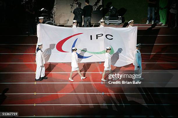 The new International Paralympic Committee flag is carried out of the stadium during the closing ceremonies for the 2004 Paralympic Games on...