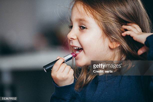 little girl's first lipstick - sweet little models stock pictures, royalty-free photos & images