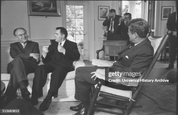 Soviet ambassador to the US, Anatoly F. Dobrynin and Soviet foreign minister Andrei Gromyko talking with President Kennedy who is seated in rocking...