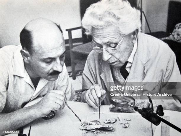 Israel's Professor yigal yadin and james biberkraut study samples from the dead sea scrolls, 1965.