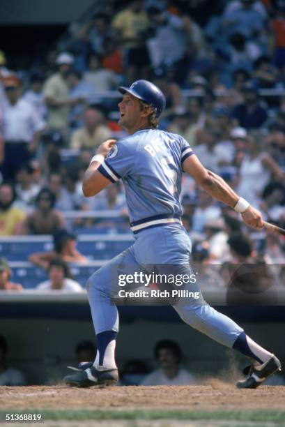 George Brett of the Kansas City Royals watches the flight as he follows through on a swing during a 1980 MLB season game.