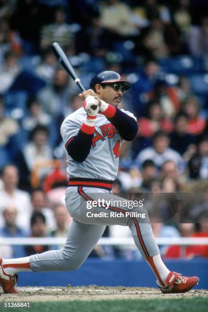 Reggie Jackson of the California Angels watches the flight of the ball as he follows through on a swing during a MLB season game circa 1983-1986.