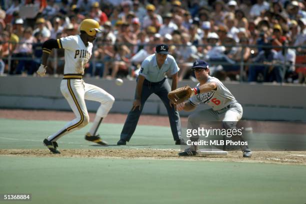Omar Moreno of the Pittsburgh Pirates moves back to first base as Steve Garvey of the Los Angeles Dodgers waits for the throw during a game circa...