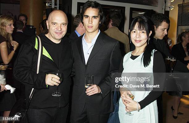 Film director Anthony Minghella, his son Max and wife Carolyn Choa attend the "Vanity Fair" Private Party at Dunhill on September 28, 2004 in London.