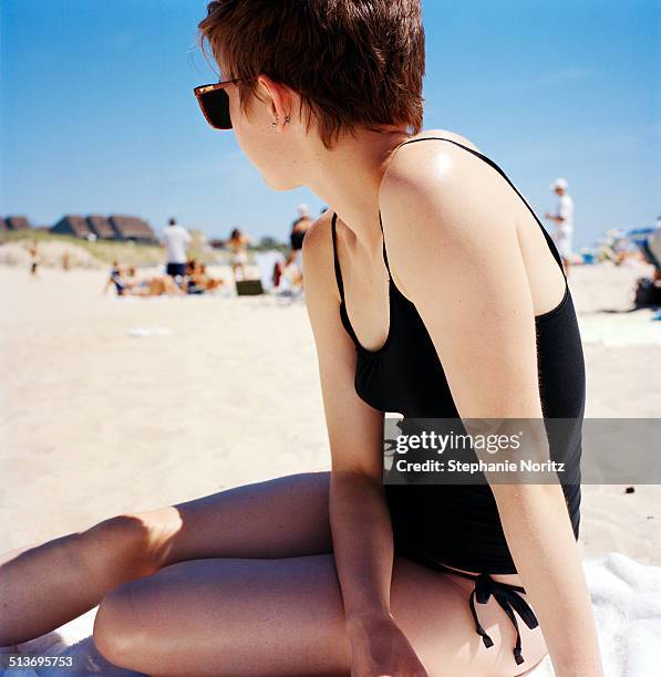 woman relaxing on beach - lightskinned stock pictures, royalty-free photos & images