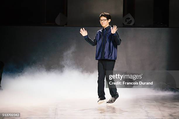 Designer Yoshiyuki Miyamae ackowledges the applause of the public after his show as part of the Paris Fashion Week Womenswear Fall/Winter 2016/2017...