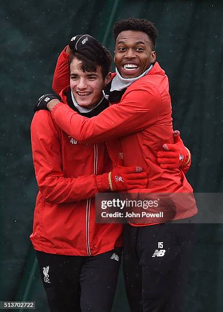 Daniel Sturridge embraces Pedro Chirivella of Liverpool during a training session at Melwood Training Ground on March 4, 2016 in Liverpool, England.
