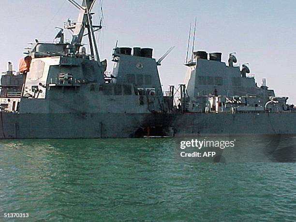 The port side of the guided missile destroyer USS Cole is damaged after a suspected terrorist bomb exploded during a refueling operation 12 October...