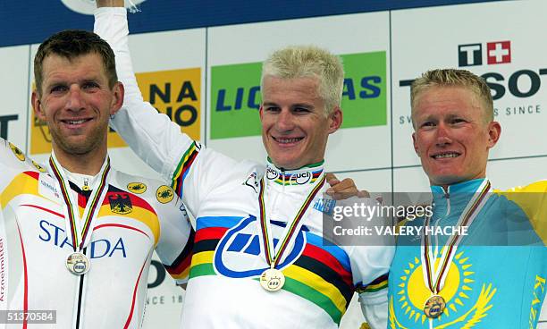 Michael Rogers of Australia, Michael Rich of Germany and Alexander Vinokourov of Kazakhstan stand on the podium after winning the elite men's...