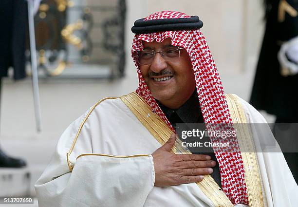 Saudi Crown Prince Mohammed bin Nayef gestures as he leaves after his meeting with French President Francois Hollande at the Elysee palace on March...