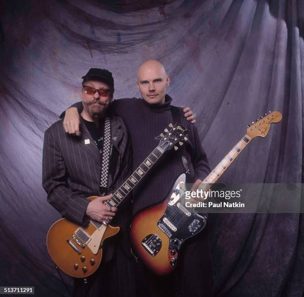Portrait of American musicians Rick Nielsen , of the band Cheap Trick, and Billy Corgan, of Smashing Pumpkins, as they pose backstage at the Metro...