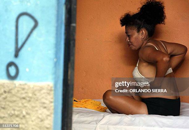 Maribel, member of the female soccer team "Estrellas de la Linea", which is constituted by prostitutes, gets ready for a training session in...