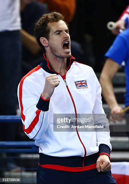 Andy Murray of Great Britain encourages teammate Daniel Evans of Great Britain during the singles match against Kei Nishikori of Japan on day one of...