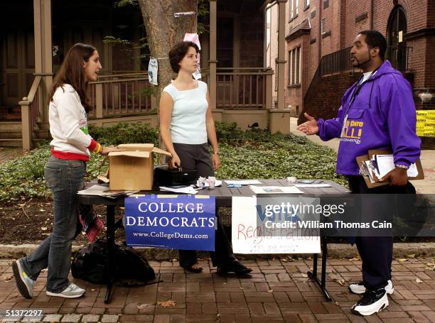 Millie Weinstein-Gould, Emma Cermak, and Gary Hilliard await students to register to vote on the University of Pennsylvanvia campus September 29,...