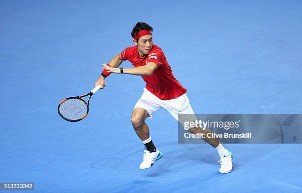 Kei Nishikori of Japan runs to play a forehand in his singles match against Daniel Evans of Great Britain during day one of the Davis Cup World Group...