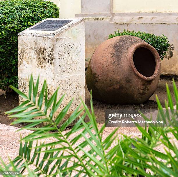 Historic plaque and clay pot in the Ignacio Agramonte plaza dedicated to five Afro Caribbean leaders who were decapitated for supporting the...