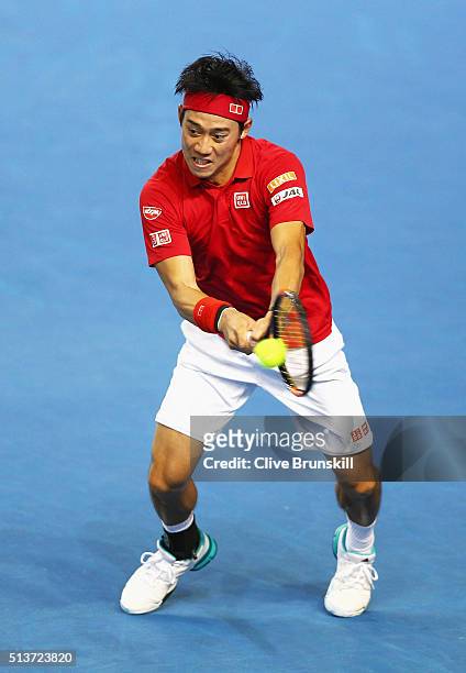Kei Nishikori of Japan plays a backhand in his singles match against Daniel Evans of Great Britain during day one of the Davis Cup World Group first...