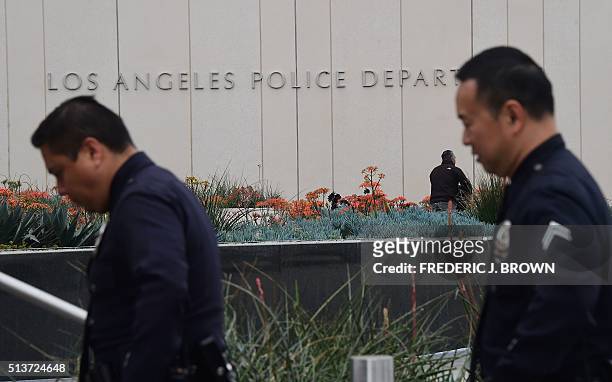Officers return to headquarters on March 4 folllowing a press conference where Los Angeles police announced an investigation into whether a knife...