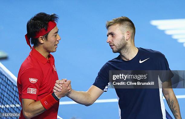 Kei Nishikori of Japan shakes hands with Daniel Evans of Great Britain after his victory in their singles match during day one of the Davis Cup World...