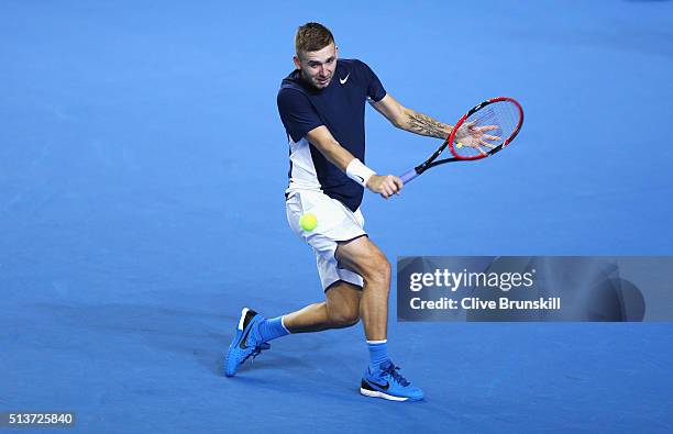 Daniel Evans of Great Britain plays a backhand in his singles match against Kei Nishikori of Japan during day one of the Davis Cup World Group first...