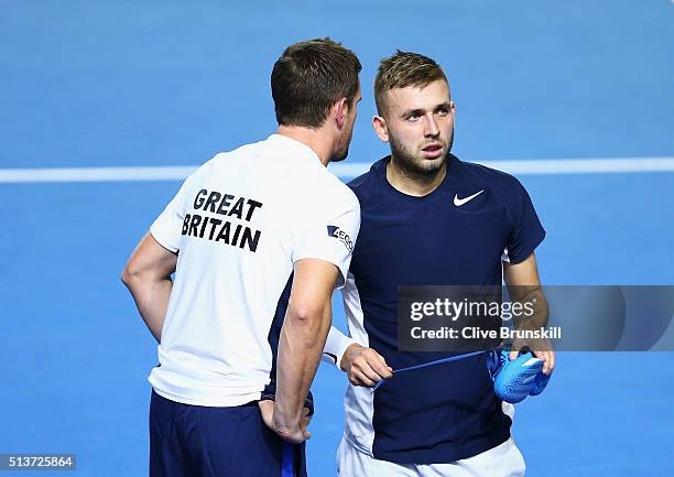 Daniel Evans of Great Britain talks with captain Leon Smith in his singles match against Kei Nishikori of Japan during day one of the Davis Cup World...