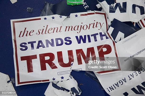 Discarded campaign posters litter the floor following a rally with Republican presidential candidate Donald Trump at Macomb Community College on...