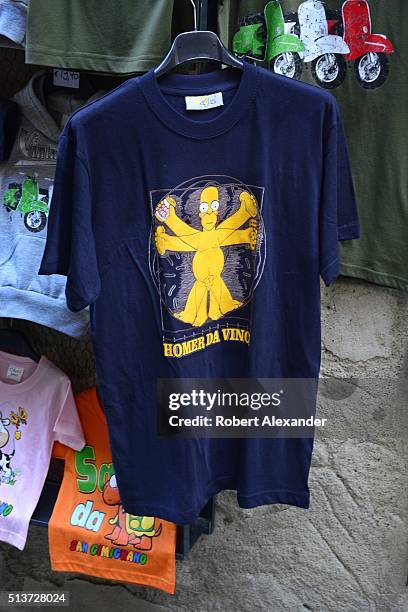 Souvenir shop in the medieval walled hill town of San Gimignano in the Tuscany region of Italy sells T-shirts with a cartoon figure of Homer Simpson...