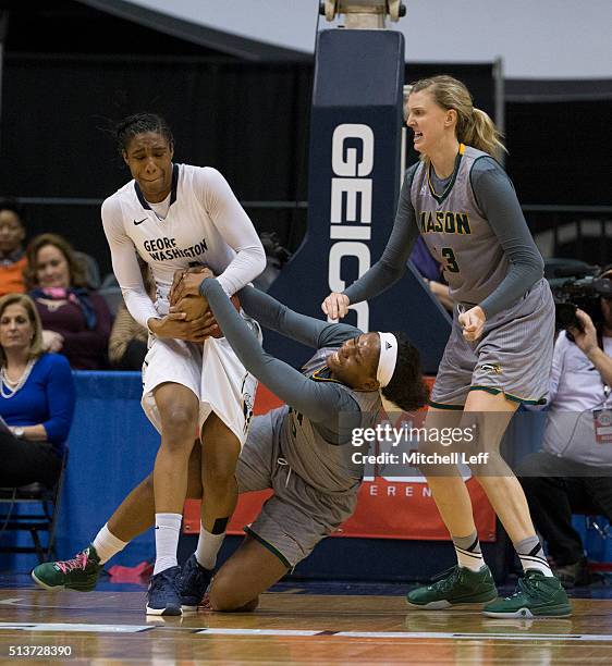 Caira Washington of the George Washington Colonials fights for the ball along with Chinyere Bell of the George Mason Patriots in the Quarterfinals of...