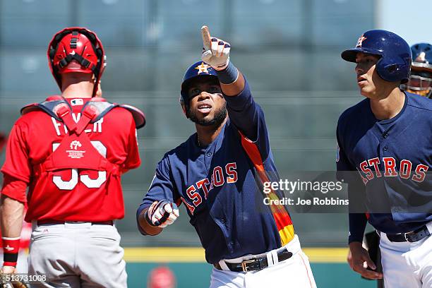 Luis Valbuena of the Houston Astros reacts after hitting a two-run home run against the St. Louis Cardinals in the first inning of a spring training...