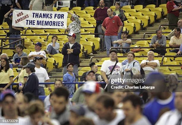 Montreal Expos fans hold a sign after the team's final home game ever against the Florida Marlins at Olympic Stadium September 29, 2004 in Montreal,...