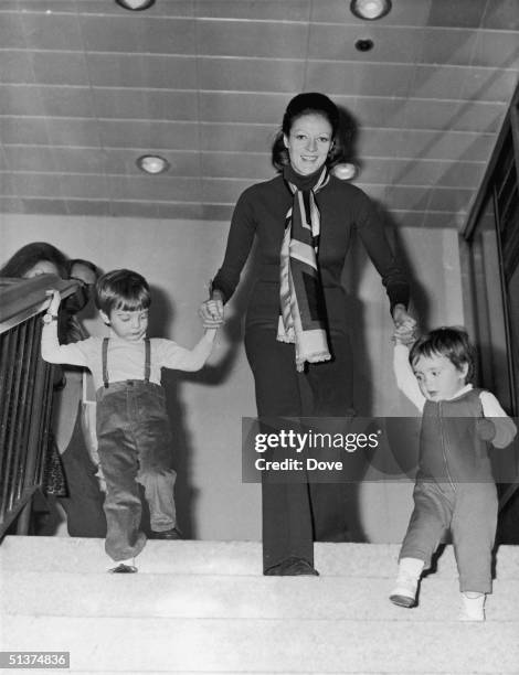 English actress Maggie Smith with her two children, Chris Larkin and Toby Stephens, at London Airport, March 1971.