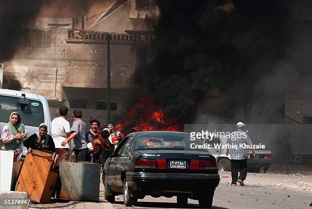 Iraqi citizen's flee the scene after three explosions September 30, 2004 in Baghdad, Iraq. Three seperate explosions near a U.S. Military convoy...