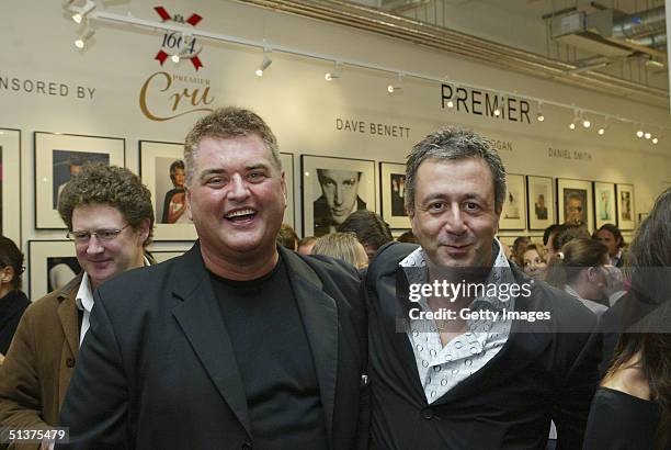 In this handout photo from Getty Images, photographers Dave Hogan and Jason Fraser are seen at the private view of the new "Premier" exhibition,...