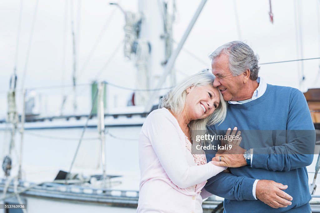 Affectionate mature couple at marina