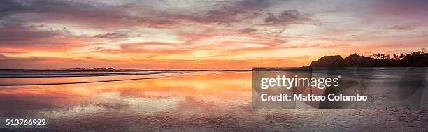 panoramic of tropical beach at sunset, costa rica - nosara costa rica stock pictures, royalty-free photos & images