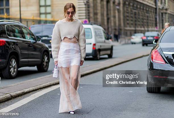 Chiara Ferragni wearing a Dior creme jumper and shee dress and white Dior bag outside Dior during the Paris Fashion Week Womenswear Fall/Winter...