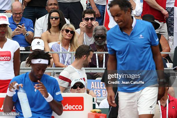 Isabelle Camus, wife of Yannick Noah and Yannick's father Zacharie Noah look on while captain of France Yannick Noah and Gael Monfils stand on the...