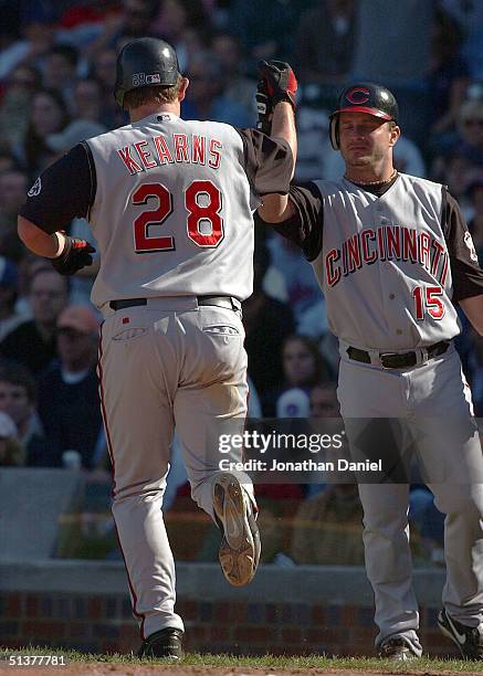 Austin Kearns of the Cincinnati Reds is congratulated by teammate Darren Bragg after hitting the game-tying home run against the Chicago Cubs in the...