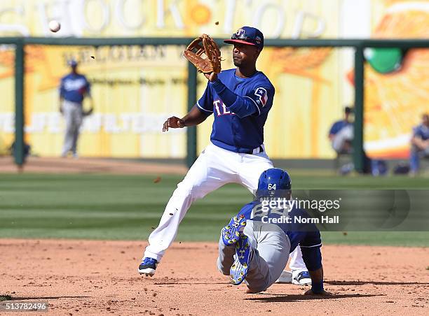 Rico Noel of the Los Angeles Dodgers attempts to steal second base as Pedro Ciriaco of the Texas Rangers waits for the throw from home plate during...