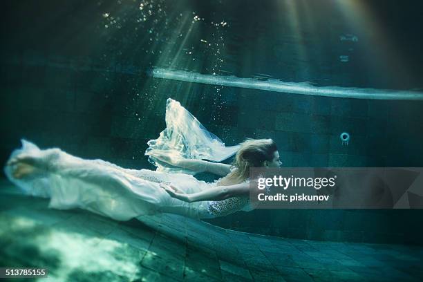 young woman underwater - underwater female models stock pictures, royalty-free photos & images