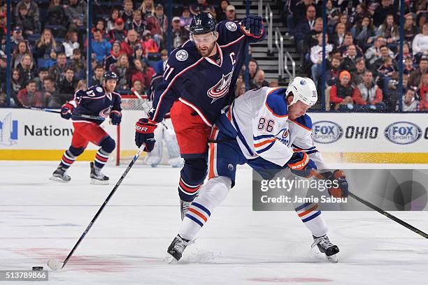 Nick Foligno of the Columbus Blue Jackets flips over Nikita Nikitin of the Edmonton Oilers during the first period of a game on March 4, 2016 at...