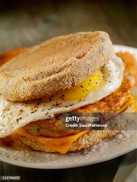 fried egg, sausage and cheese breakfast sandwich - breakfast sausage stock pictures, royalty-free photos & images